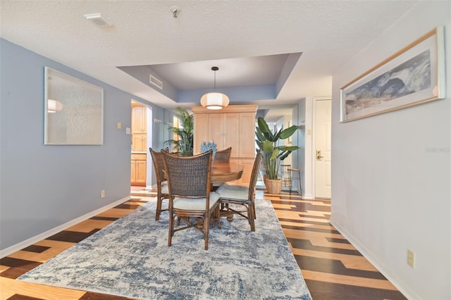 dining room featuring a textured ceiling and hardwood / wood-style flooring