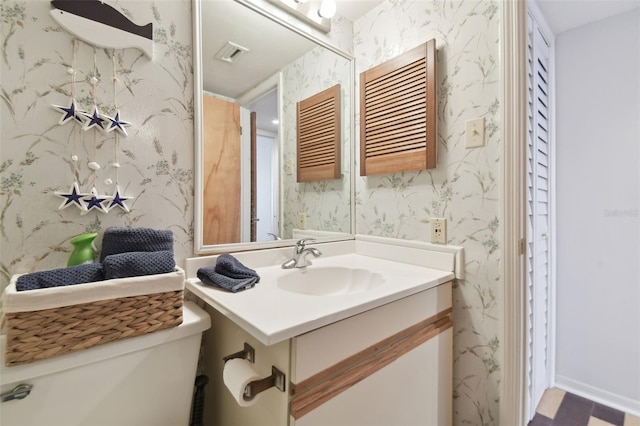 bathroom with vanity and toilet