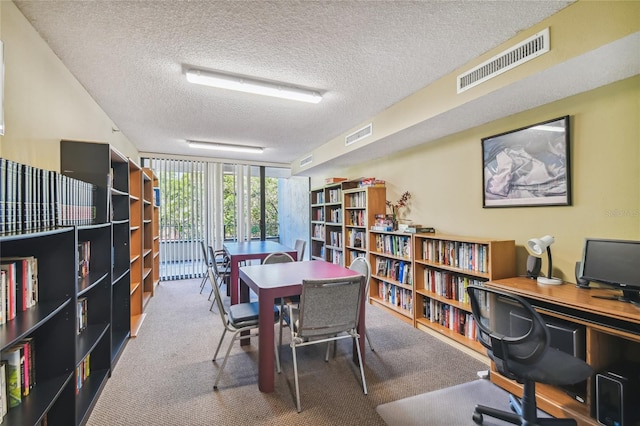 office area featuring carpet flooring and a textured ceiling