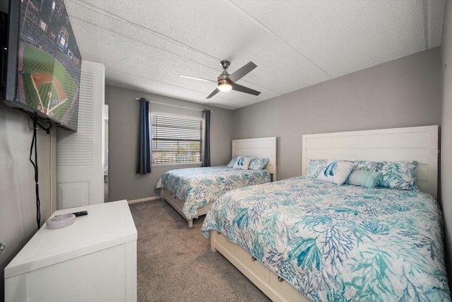 carpeted bedroom with a textured ceiling and ceiling fan