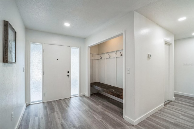 mudroom featuring recessed lighting, baseboards, a textured ceiling, and wood finished floors