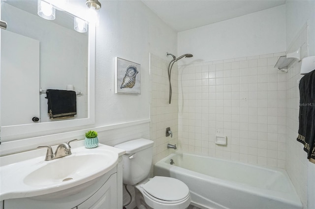 full bathroom with vanity, toilet, and tiled shower / bath