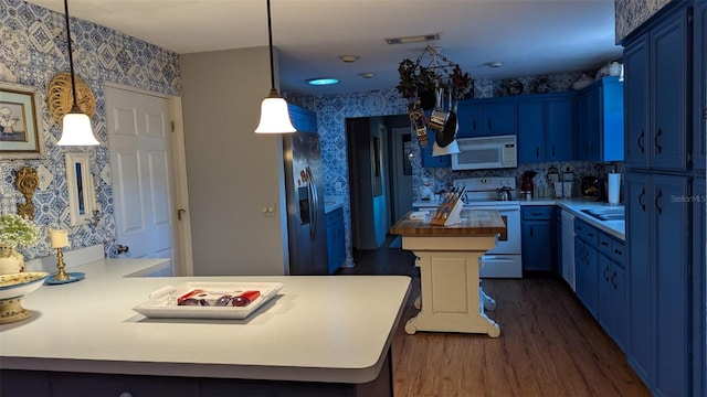 kitchen featuring white appliances, dark hardwood / wood-style floors, blue cabinets, and butcher block countertops