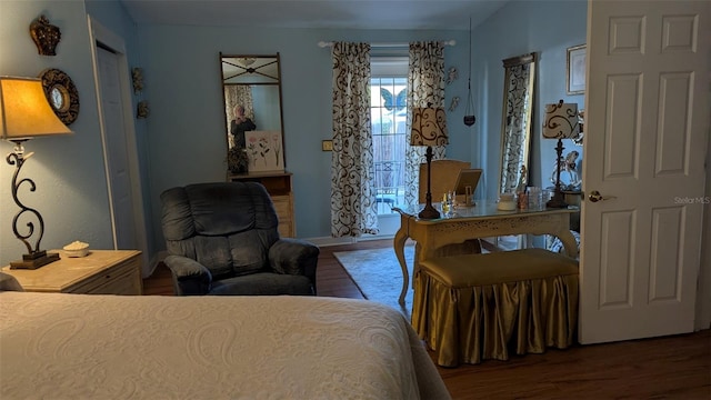 bedroom with dark hardwood / wood-style floors