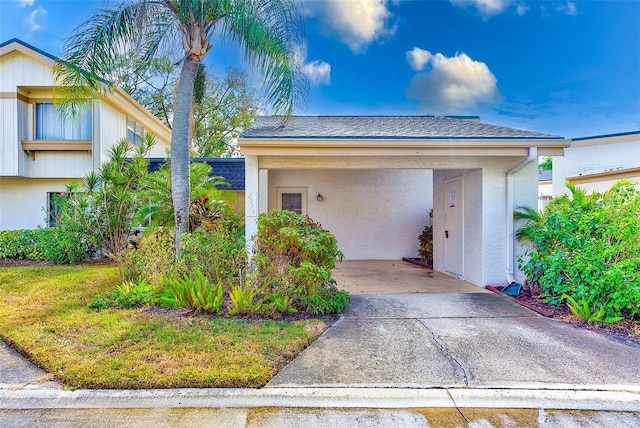 exterior space featuring a lawn and a carport