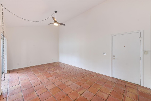 tiled empty room with ceiling fan and high vaulted ceiling