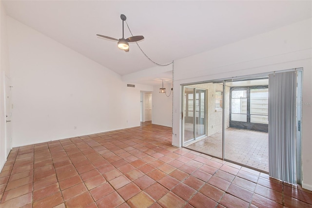 spare room with a chandelier and vaulted ceiling