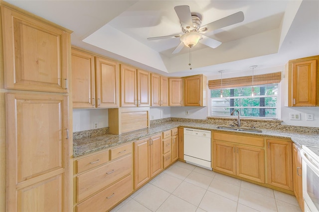 kitchen with a tray ceiling, ceiling fan, sink, and white appliances