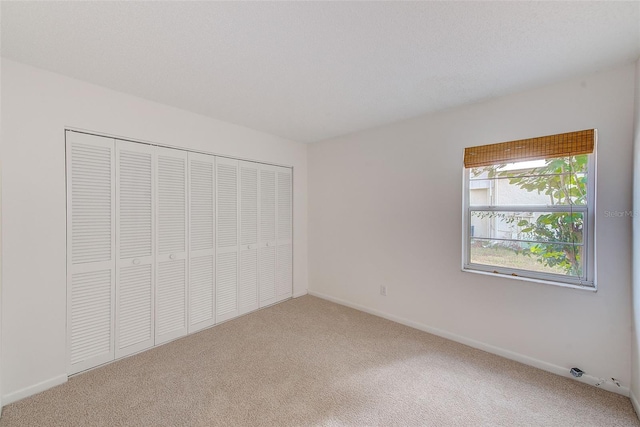 unfurnished bedroom with carpet and a closet