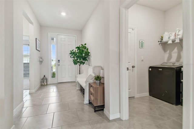 entrance foyer with light tile patterned floors and washer / clothes dryer