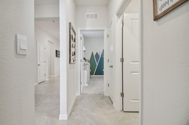 hallway featuring light tile patterned flooring