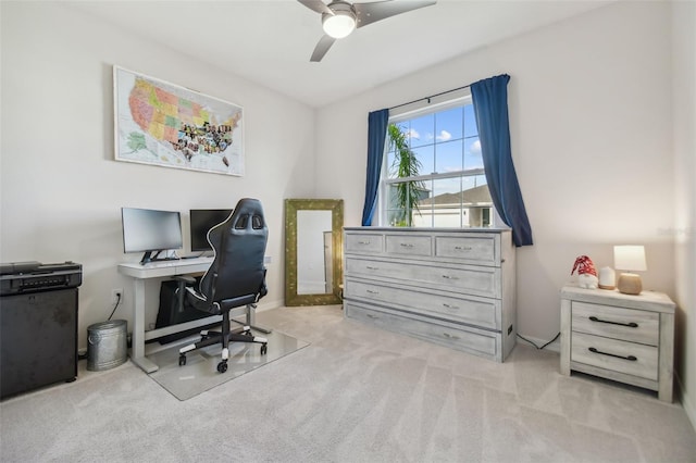 home office featuring light carpet and ceiling fan