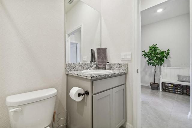 bathroom with tile patterned floors, vanity, and toilet