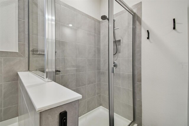 bathroom with a shower with door