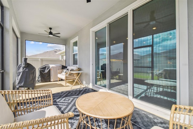 sunroom / solarium featuring ceiling fan