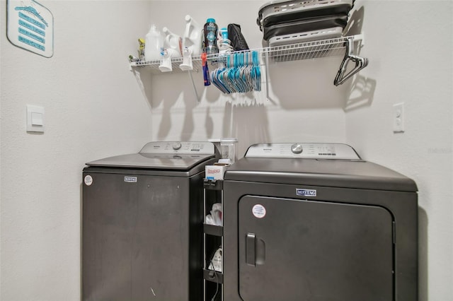 clothes washing area with washer and dryer