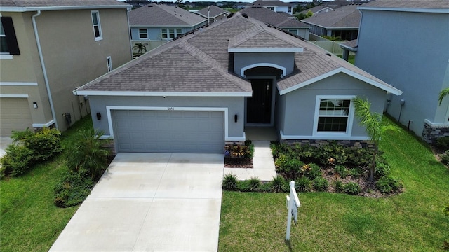 10058 Shoreline View Way, Wesley Chapel, FL 33545 - view of front of property with roof with shingles, stucco siding, an attached garage, and a residential view