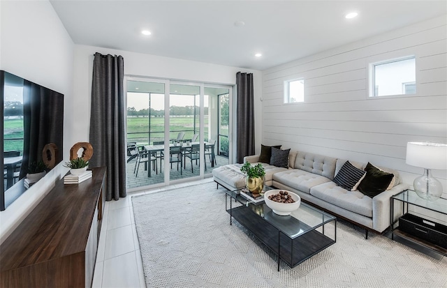 tiled living room with wood walls and plenty of natural light