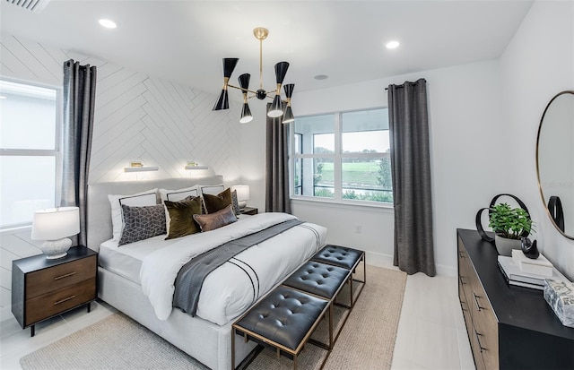 tiled bedroom featuring an inviting chandelier