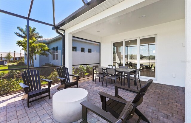 view of patio / terrace featuring a lanai