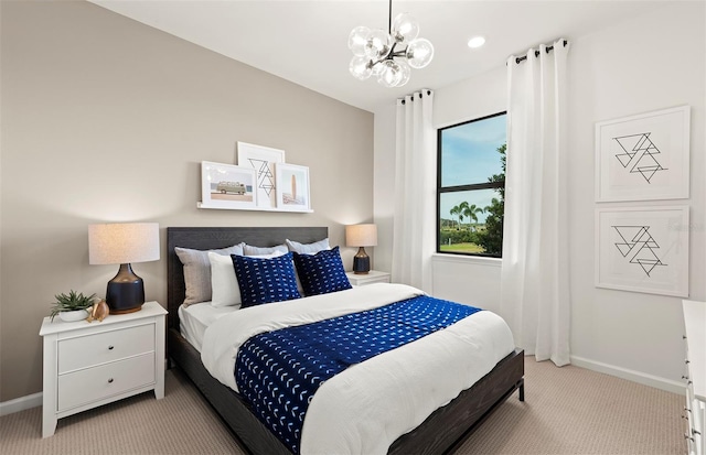 bedroom featuring a notable chandelier, light colored carpet, and baseboards