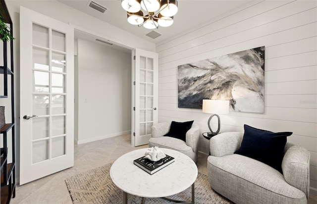 sitting room featuring visible vents, carpet flooring, french doors, and an inviting chandelier