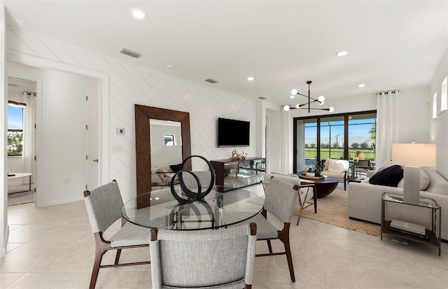 dining space with a notable chandelier, recessed lighting, baseboards, and visible vents