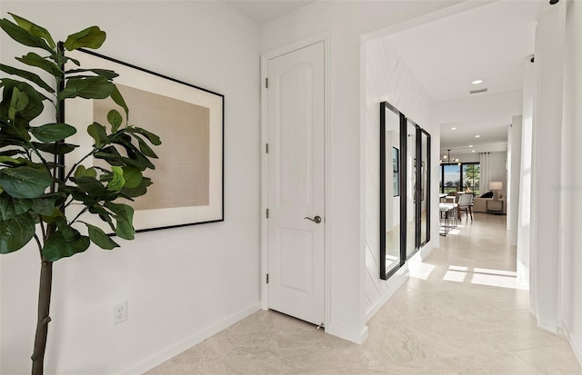 corridor with recessed lighting and baseboards