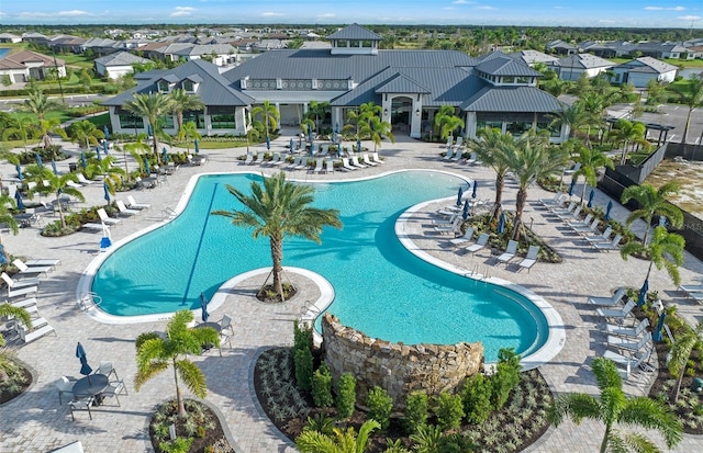 community pool with a residential view and a patio