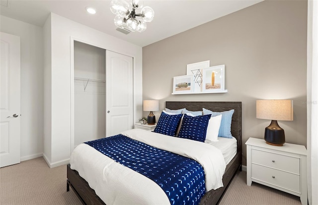 carpeted bedroom with visible vents, a notable chandelier, baseboards, and a closet