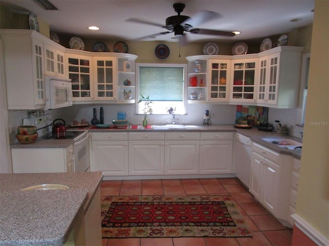 kitchen featuring white cabinetry, sink, light stone counters, and white appliances