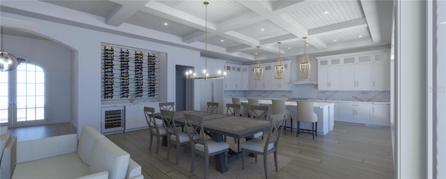 dining space with coffered ceiling, wine cooler, beamed ceiling, a notable chandelier, and wood-type flooring