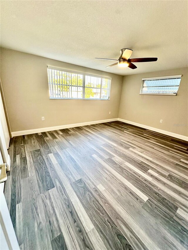 unfurnished room featuring wood-type flooring, a textured ceiling, and ceiling fan