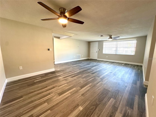 unfurnished room with a textured ceiling, dark hardwood / wood-style flooring, and ceiling fan