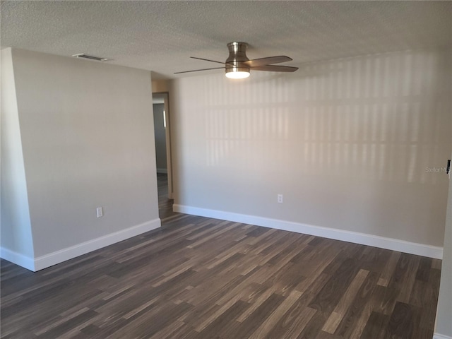 empty room with a textured ceiling, ceiling fan, and dark wood-type flooring