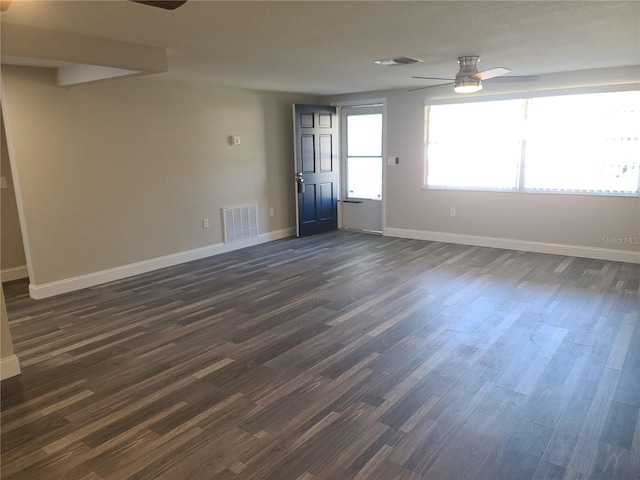 unfurnished room featuring ceiling fan and dark wood-type flooring