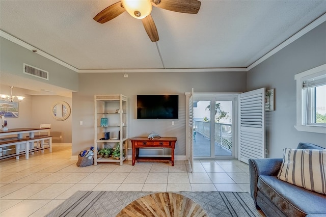 tiled living room featuring ceiling fan with notable chandelier, ornamental molding, and a textured ceiling