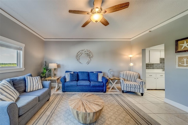 tiled living room featuring ceiling fan, ornamental molding, and a textured ceiling