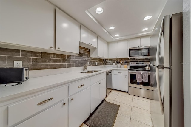 kitchen with white cabinets, light tile patterned flooring, sink, and appliances with stainless steel finishes