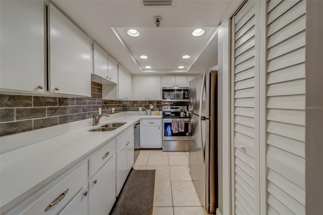 kitchen with white cabinetry, sink, and appliances with stainless steel finishes