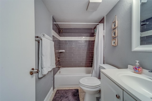 full bathroom with a textured ceiling, vanity, shower / bath combo with shower curtain, tile patterned flooring, and toilet