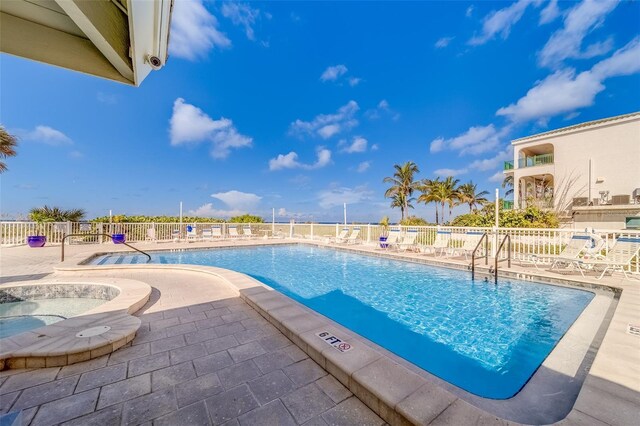 view of swimming pool with a patio area and a community hot tub