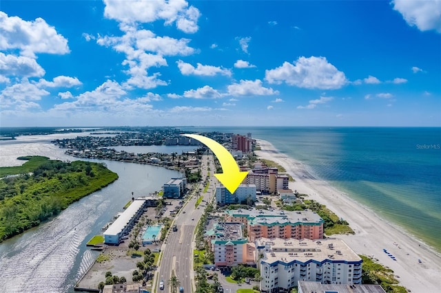 birds eye view of property with a water view and a beach view