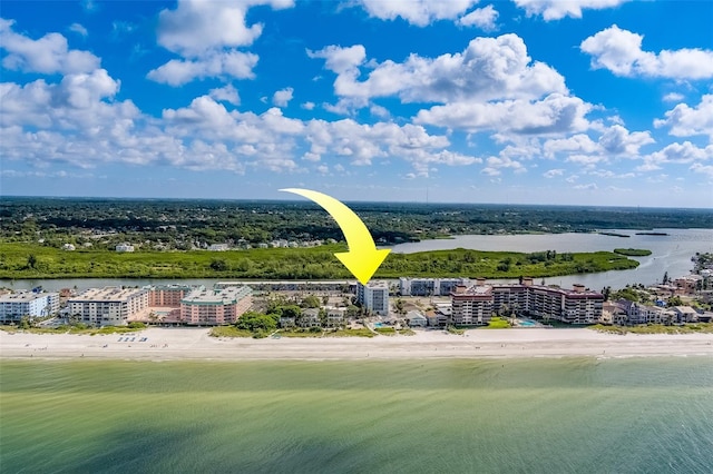 birds eye view of property featuring a water view and a beach view