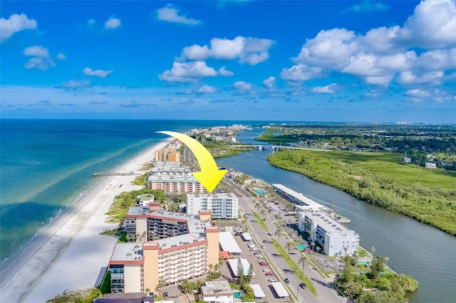 drone / aerial view featuring a beach view and a water view