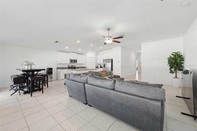 living room with ceiling fan and light tile patterned floors