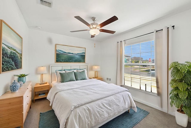 bedroom featuring carpet floors, ceiling fan, visible vents, and baseboards