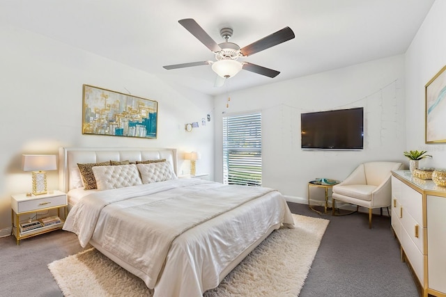 bedroom featuring ceiling fan, dark carpet, and baseboards