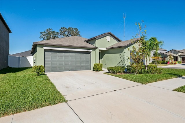 ranch-style home with an attached garage, fence, concrete driveway, stucco siding, and a front lawn