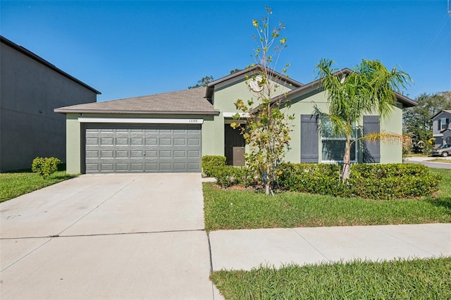 ranch-style house with an attached garage, driveway, a front lawn, and stucco siding